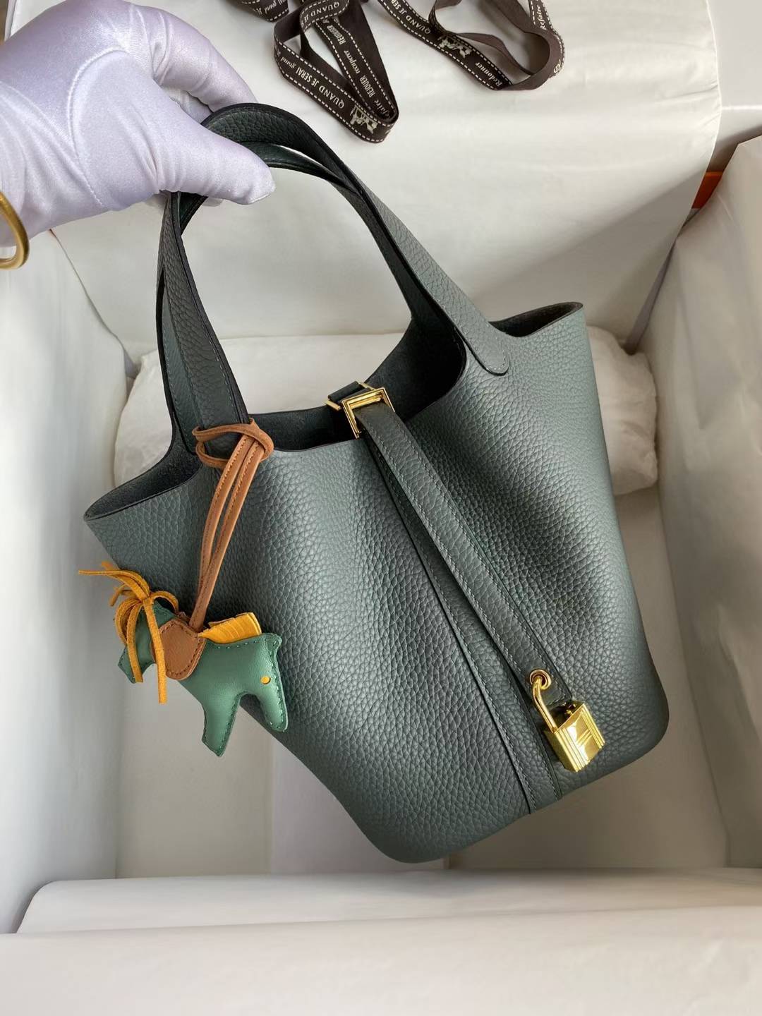 Hermès Picotin Lock 18 bag in a green shade, likely Vert Mangrove or Gris Meyer, featuring Clemence leather and gold hardware