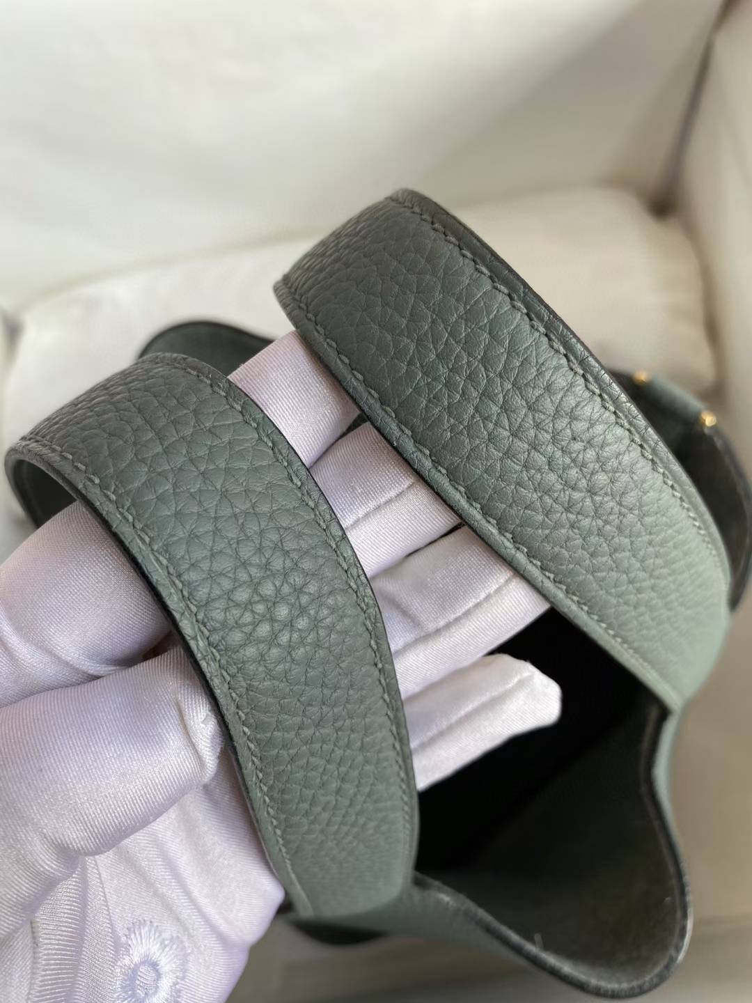 Hermès Picotin Lock 18 bag in a green shade, likely Vert Mangrove or Gris Meyer, featuring Clemence leather and gold hardware