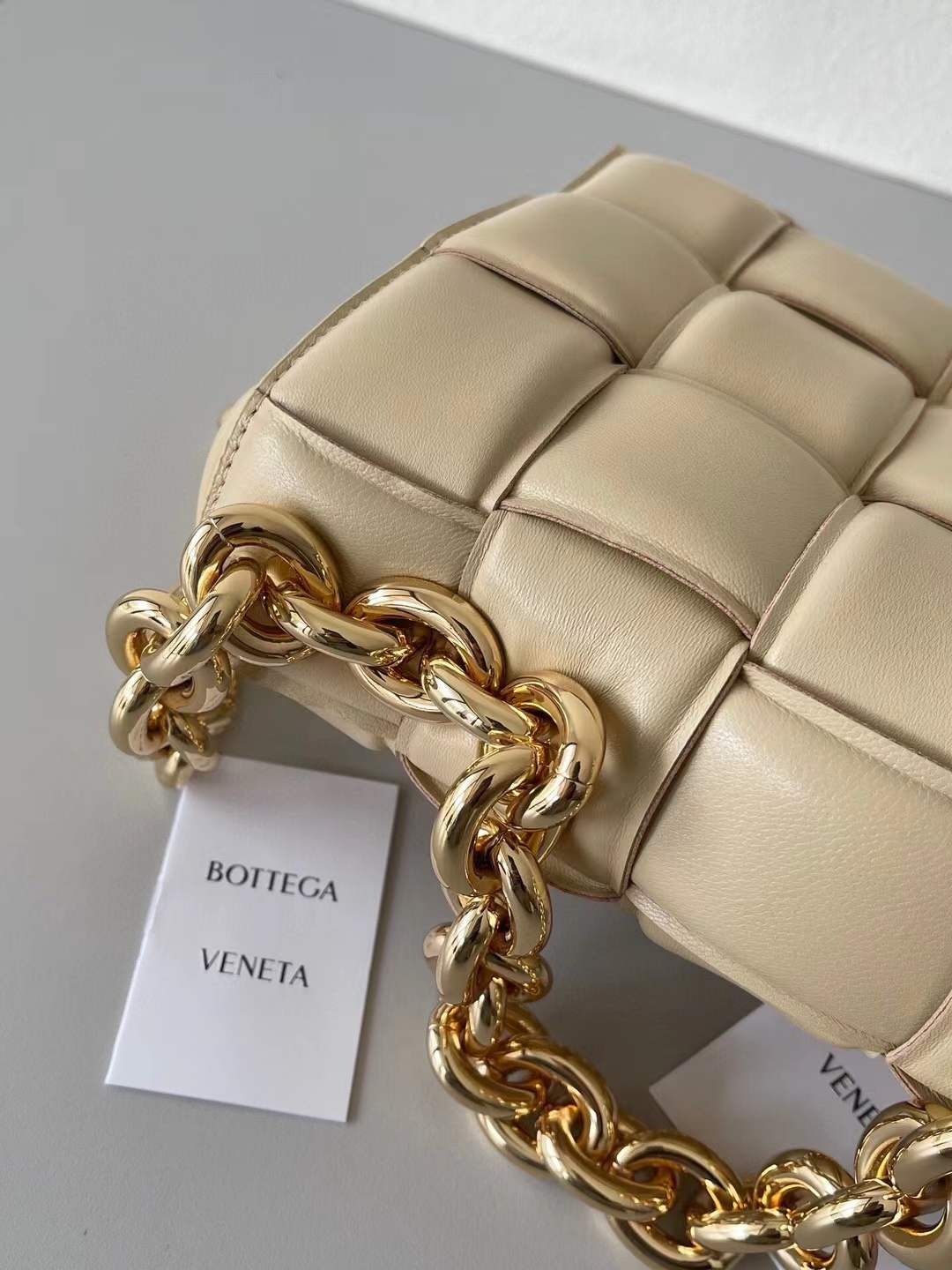 Bottega Veneta Chain Cassette Shoulder Bag in a beige leather with a padded weave and gold chain