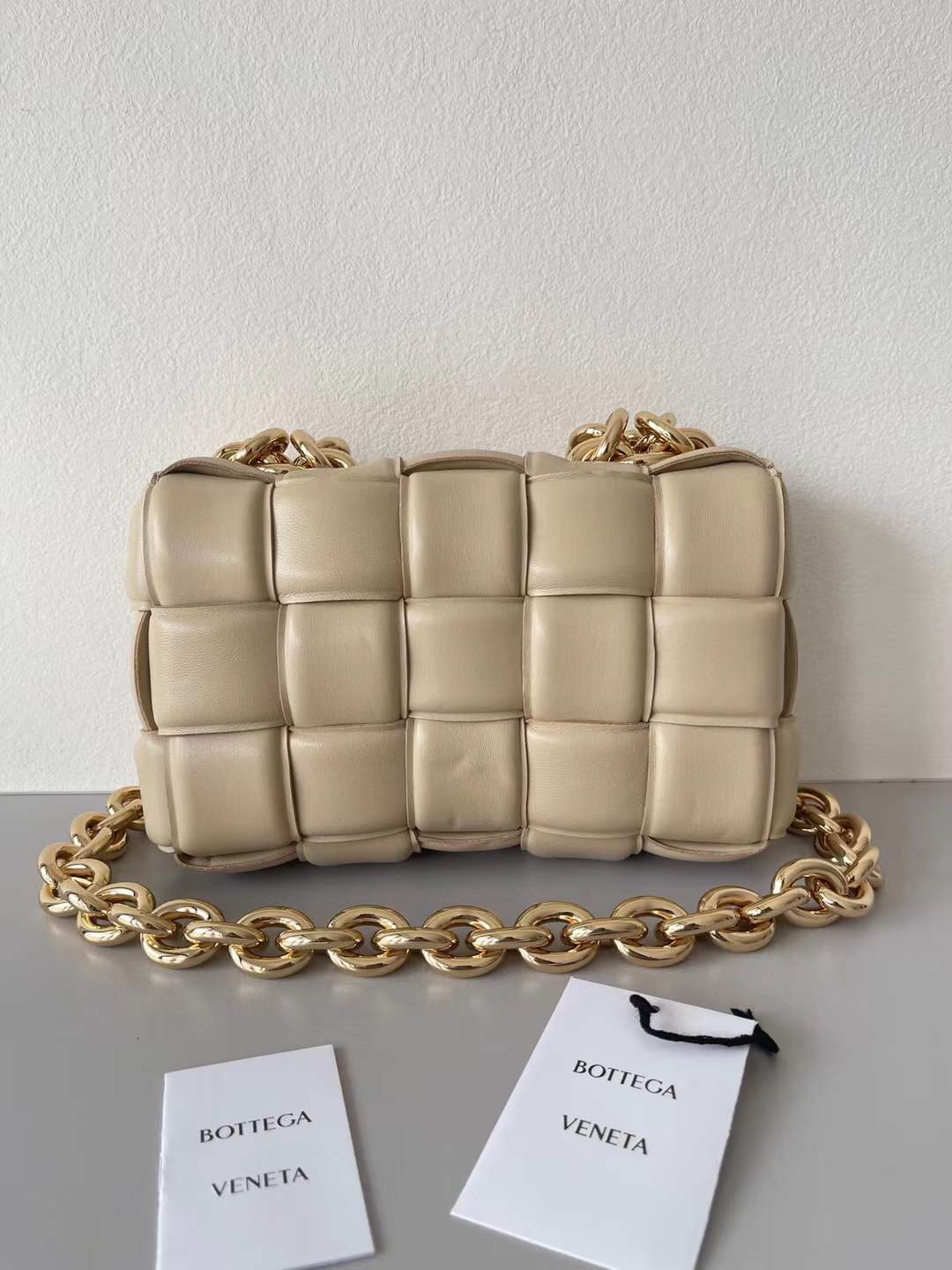 Bottega Veneta Chain Cassette Shoulder Bag in a beige leather with a padded weave and gold chain