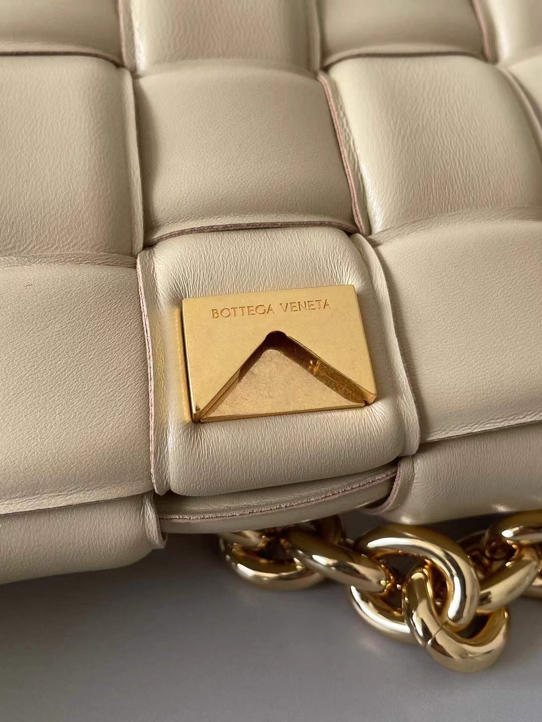 Bottega Veneta Chain Cassette Shoulder Bag in a beige leather with a padded weave and gold chain