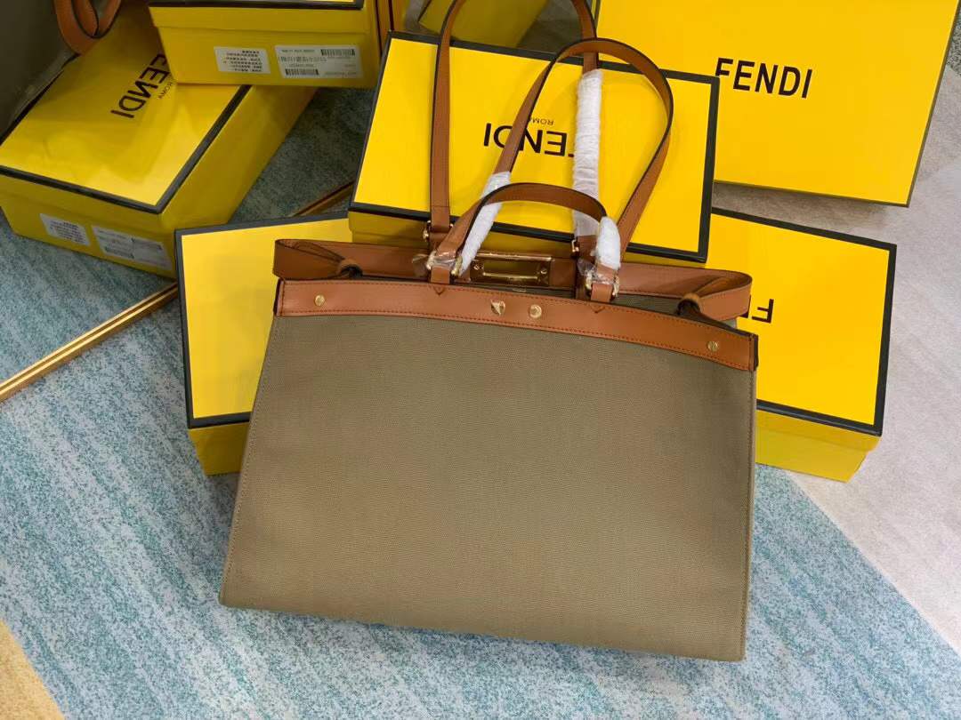 Fendi Peekaboo X-Tote bag features the iconic FF monogram pattern on canvas, brown leather trim, and gold-tone hardware