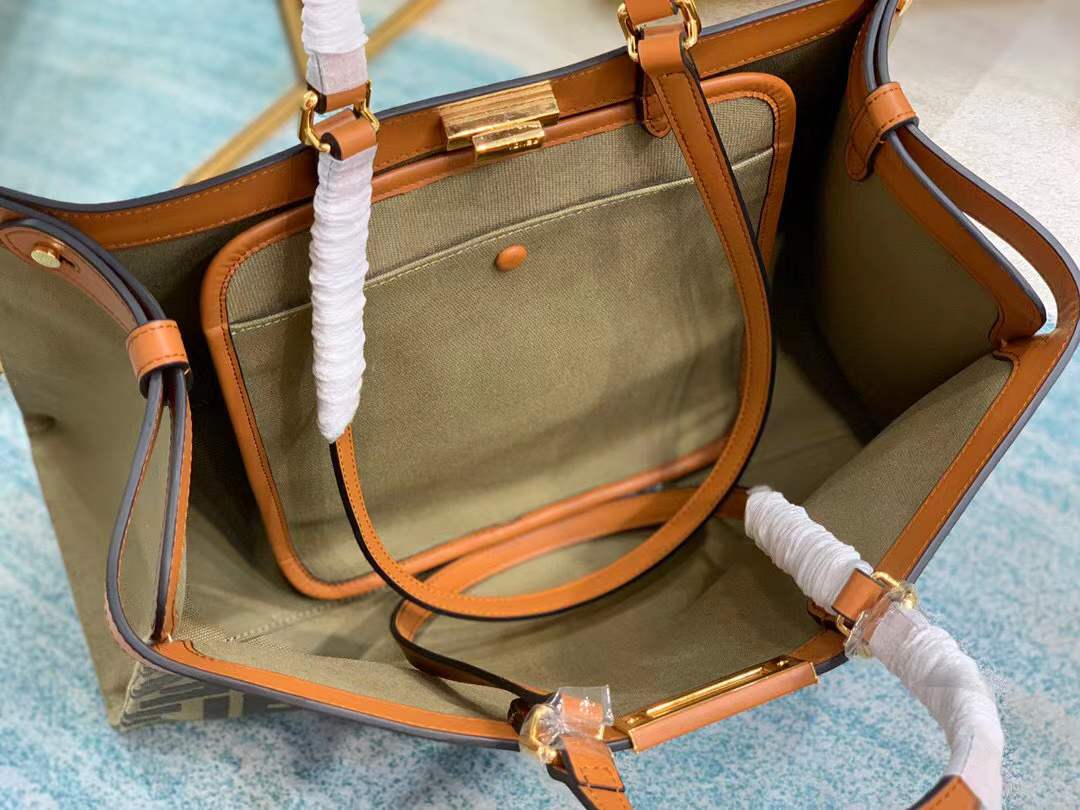 Fendi Peekaboo X-Tote bag features the iconic FF monogram pattern on canvas, brown leather trim, and gold-tone hardware