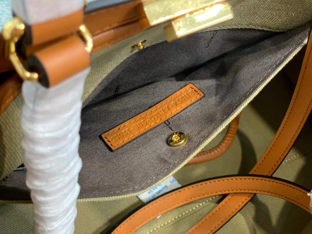 Fendi Peekaboo X-Tote bag features the iconic FF monogram pattern on canvas, brown leather trim, and gold-tone hardware