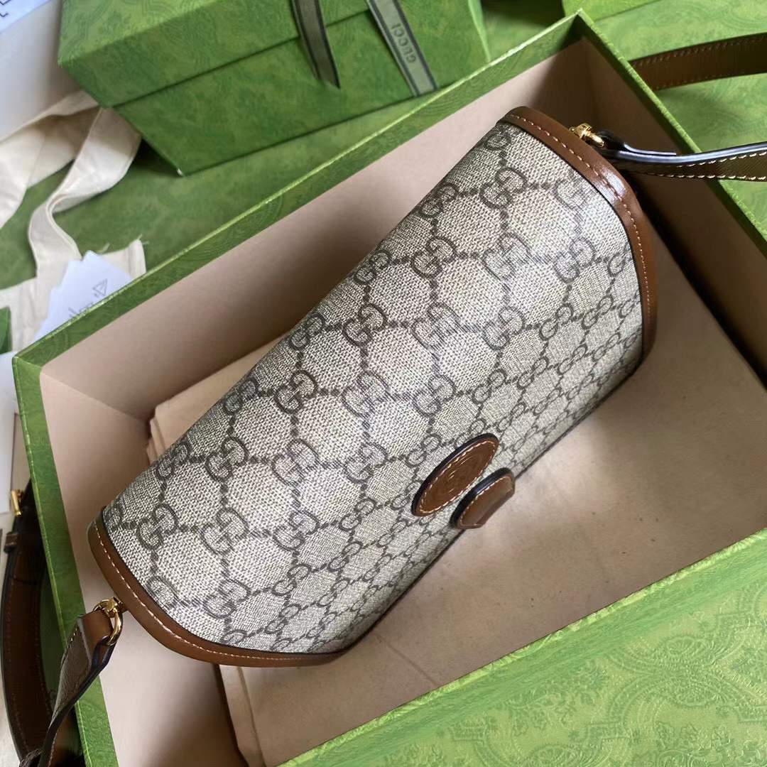 Gucci GG Supreme canvas shoulder bag, identifiable by its signature monogram canvas and leather trim