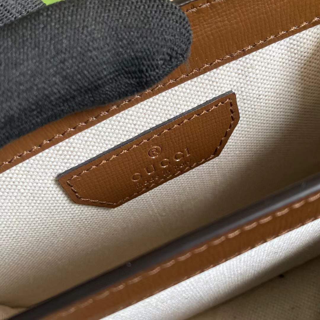 Gucci GG Supreme canvas shoulder bag, identifiable by its signature monogram canvas and leather trim