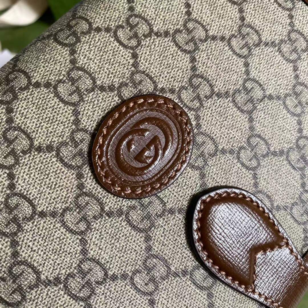 Gucci GG Supreme canvas shoulder bag, identifiable by its signature monogram canvas and leather trim