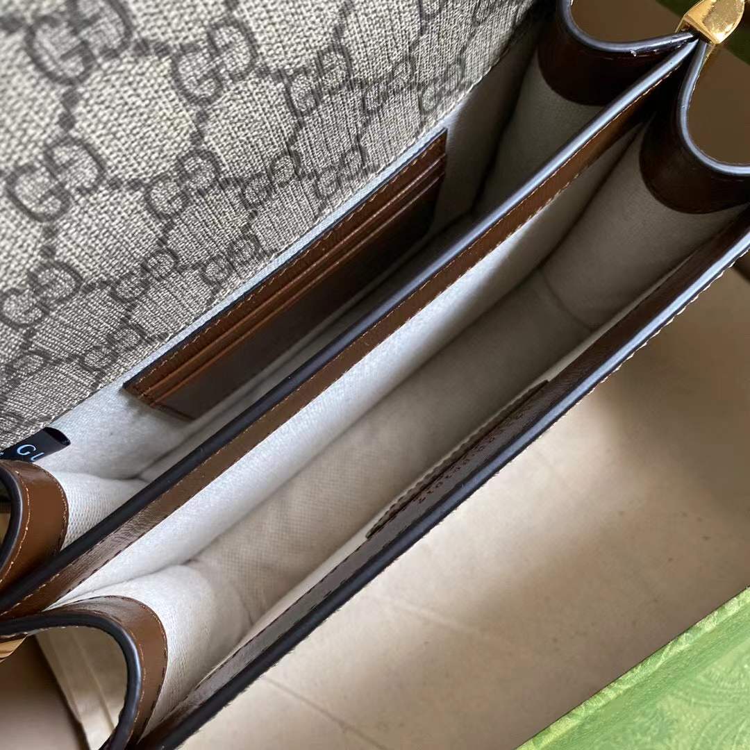 Gucci GG Supreme canvas shoulder bag, identifiable by its signature monogram canvas and leather trim