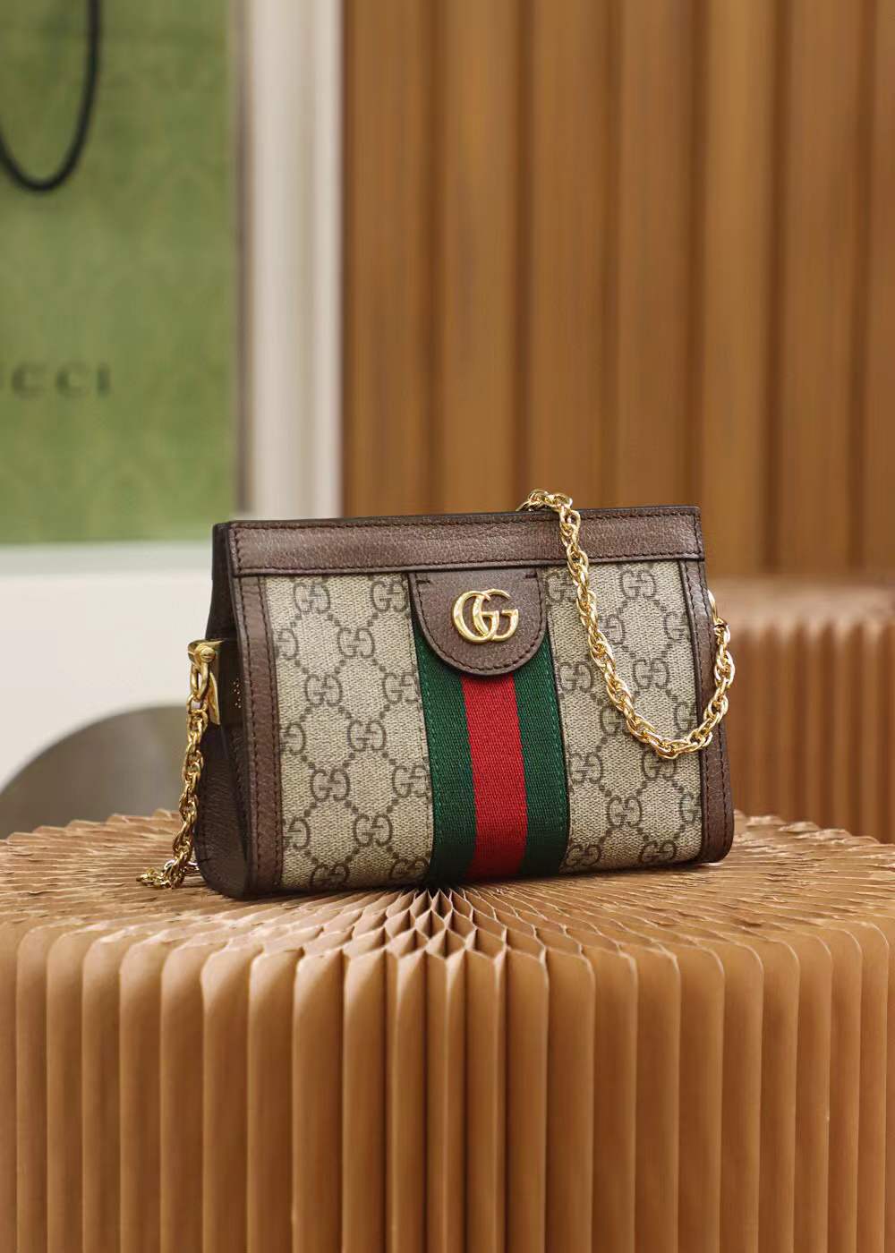 Gucci Small Ophidia shoulder bag featuring the iconic GG Supreme canvas and signature Web stripe