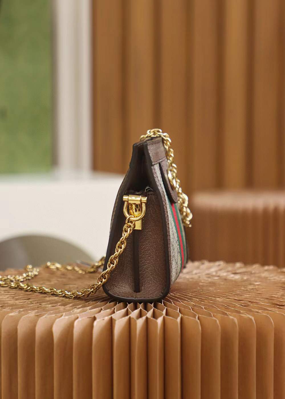 Gucci Small Ophidia shoulder bag featuring the iconic GG Supreme canvas and signature Web stripe