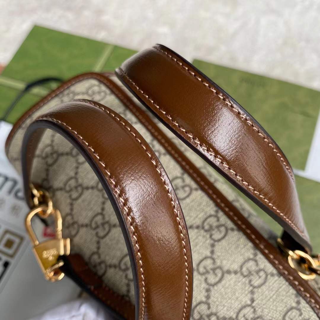 Gucci Horsebit 1955 Mini Top Handle Bag crafted from the brand's signature supreme canvas with brown leather trim