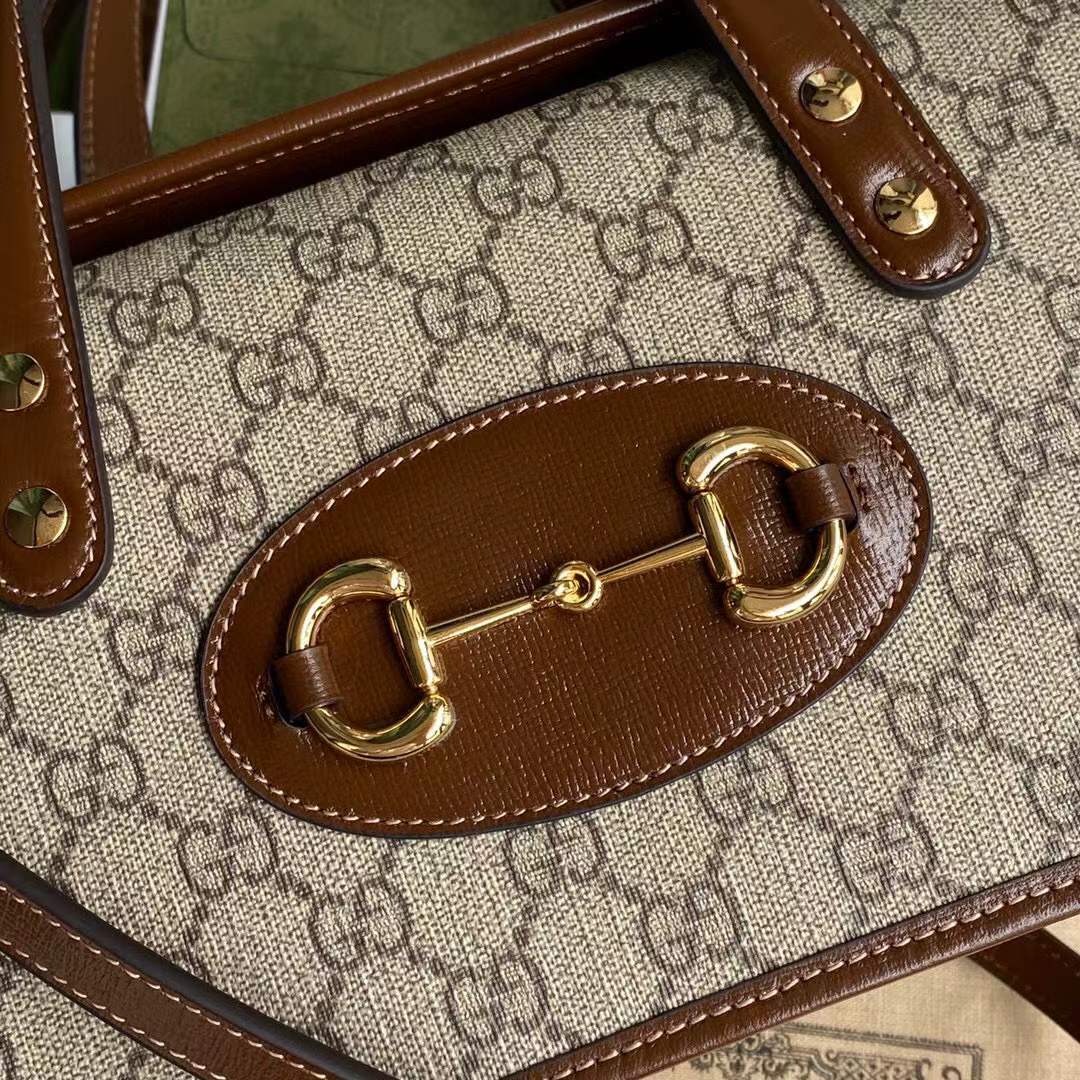Gucci Horsebit 1955 Mini Top Handle Bag crafted from the brand's signature supreme canvas with brown leather trim