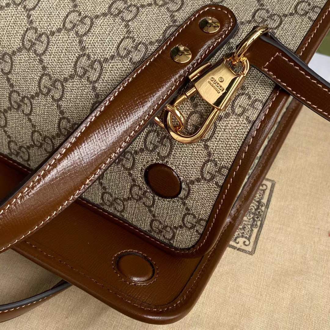 Gucci Horsebit 1955 Mini Top Handle Bag crafted from the brand's signature supreme canvas with brown leather trim