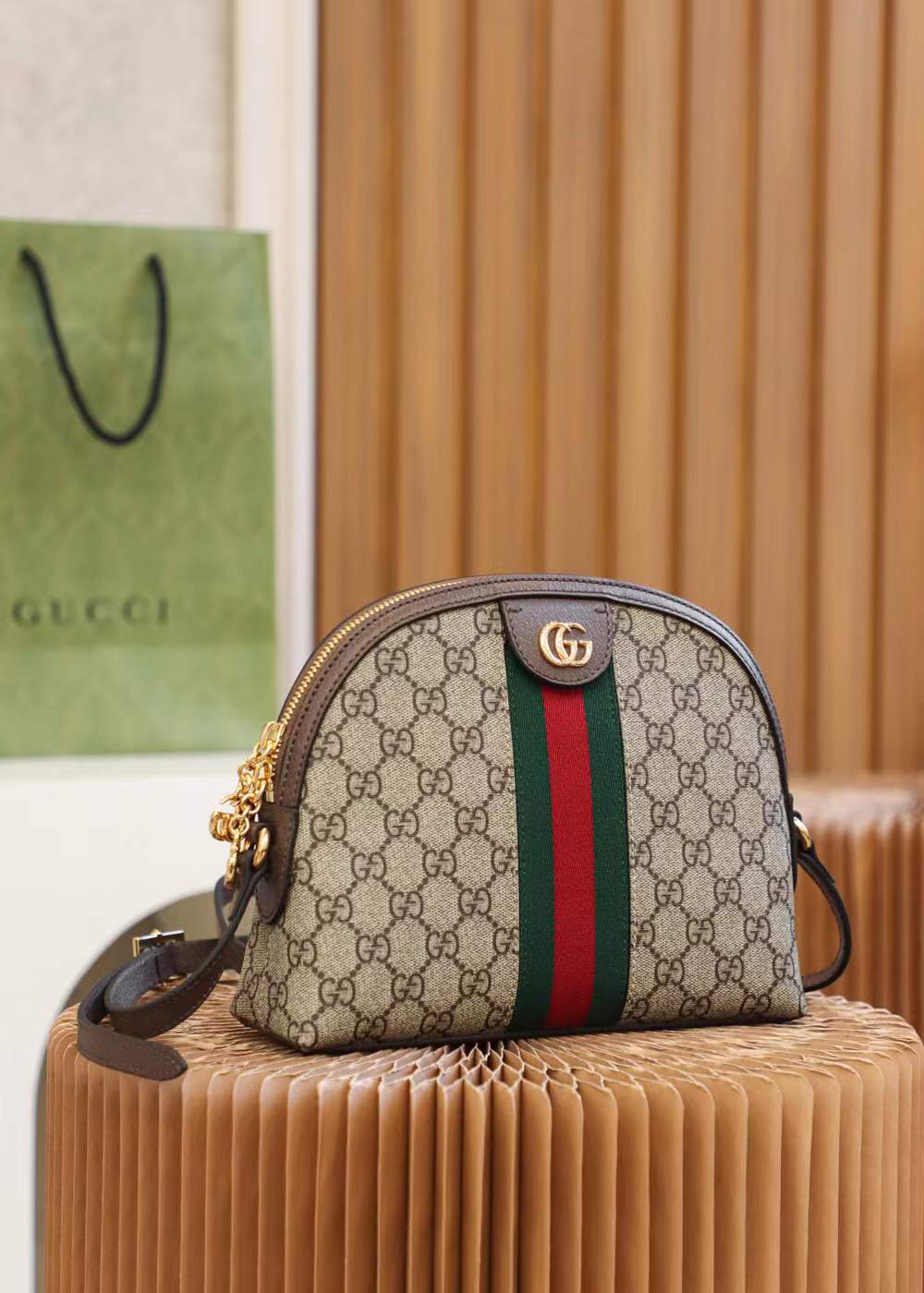 Gucci Ophidia Small GG Supreme Shoulder Bag, a dome-shaped canvas bag featuring the iconic green and red Web stripe and golden Double G hardware