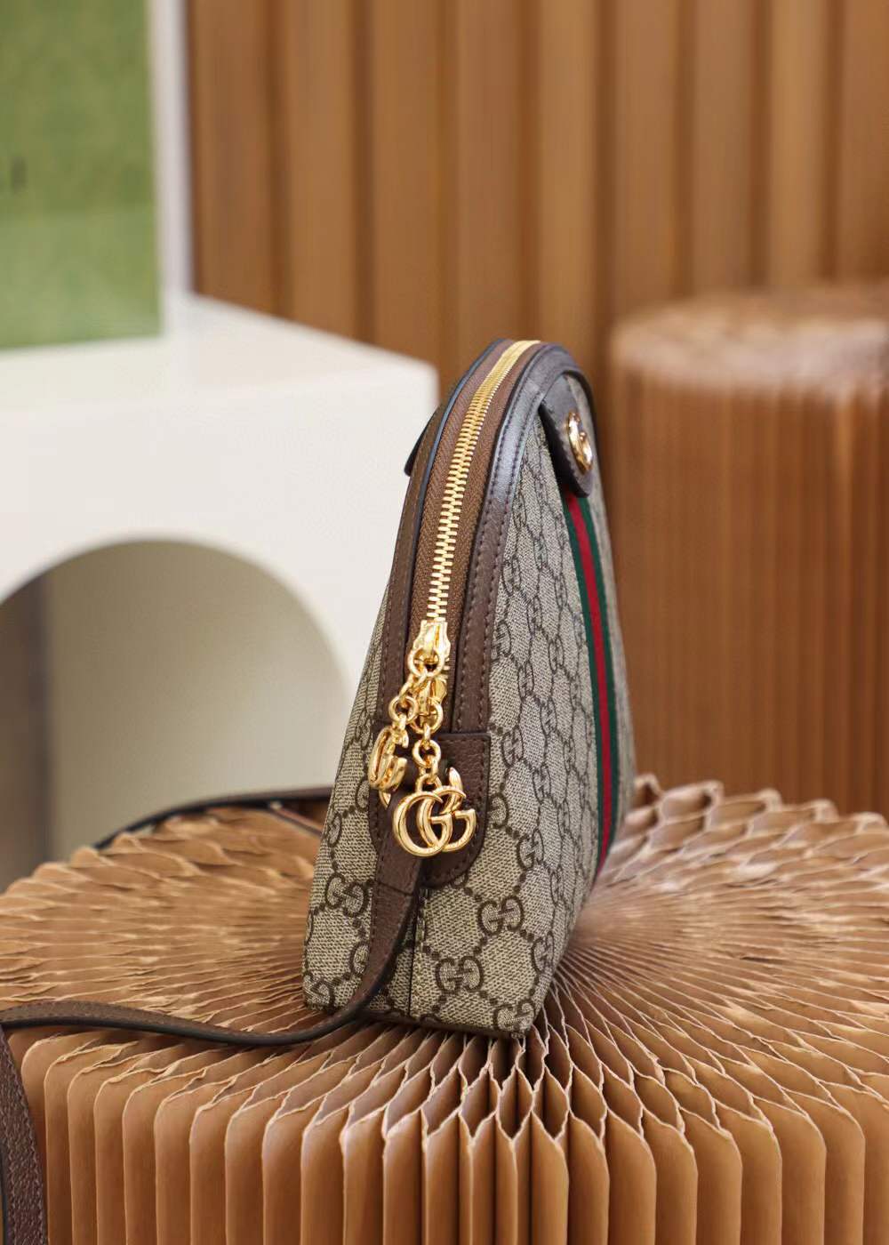 Gucci Ophidia Small GG Supreme Shoulder Bag, a dome-shaped canvas bag featuring the iconic green and red Web stripe and golden Double G hardware