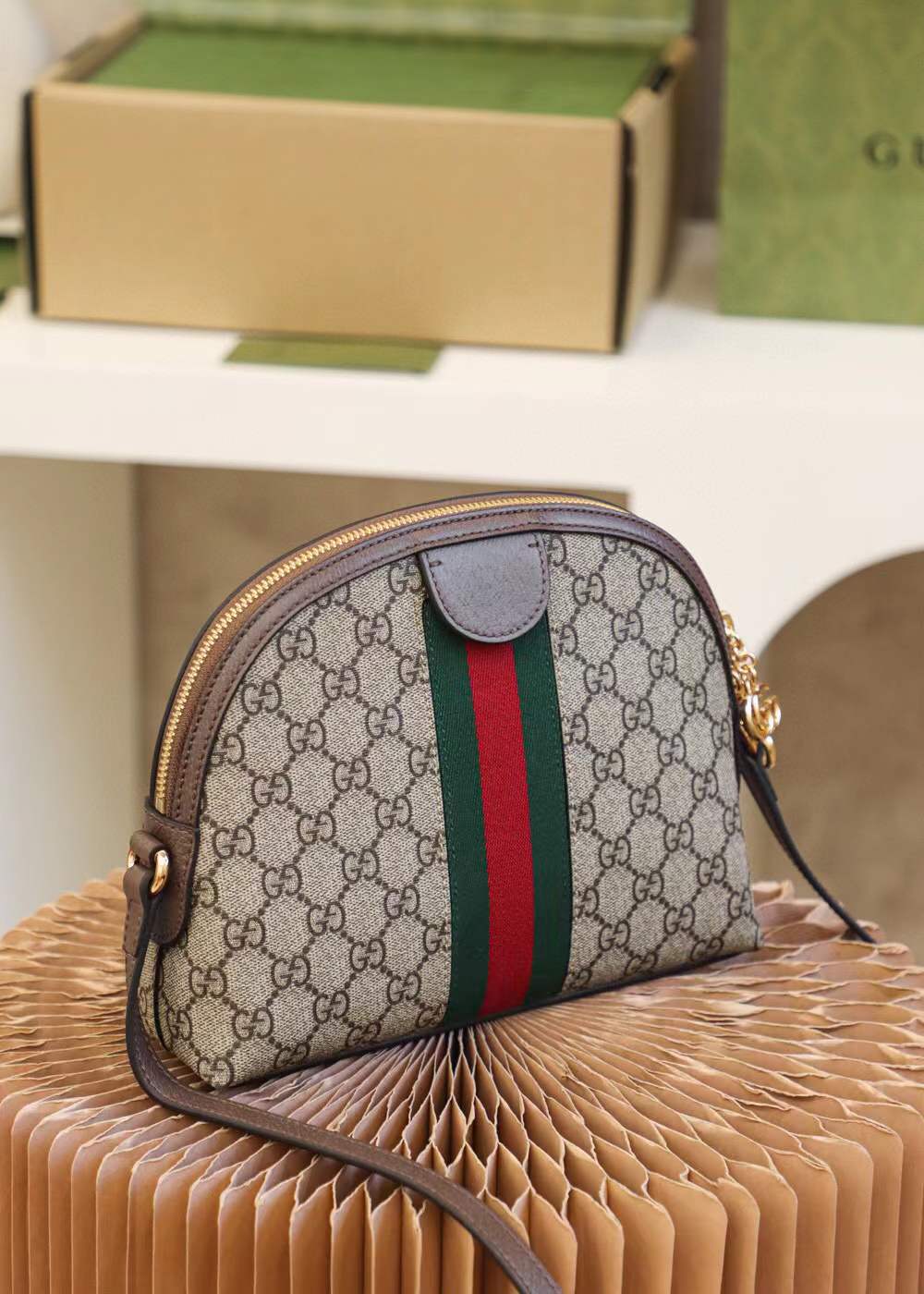 Gucci Ophidia Small GG Supreme Shoulder Bag, a dome-shaped canvas bag featuring the iconic green and red Web stripe and golden Double G hardware