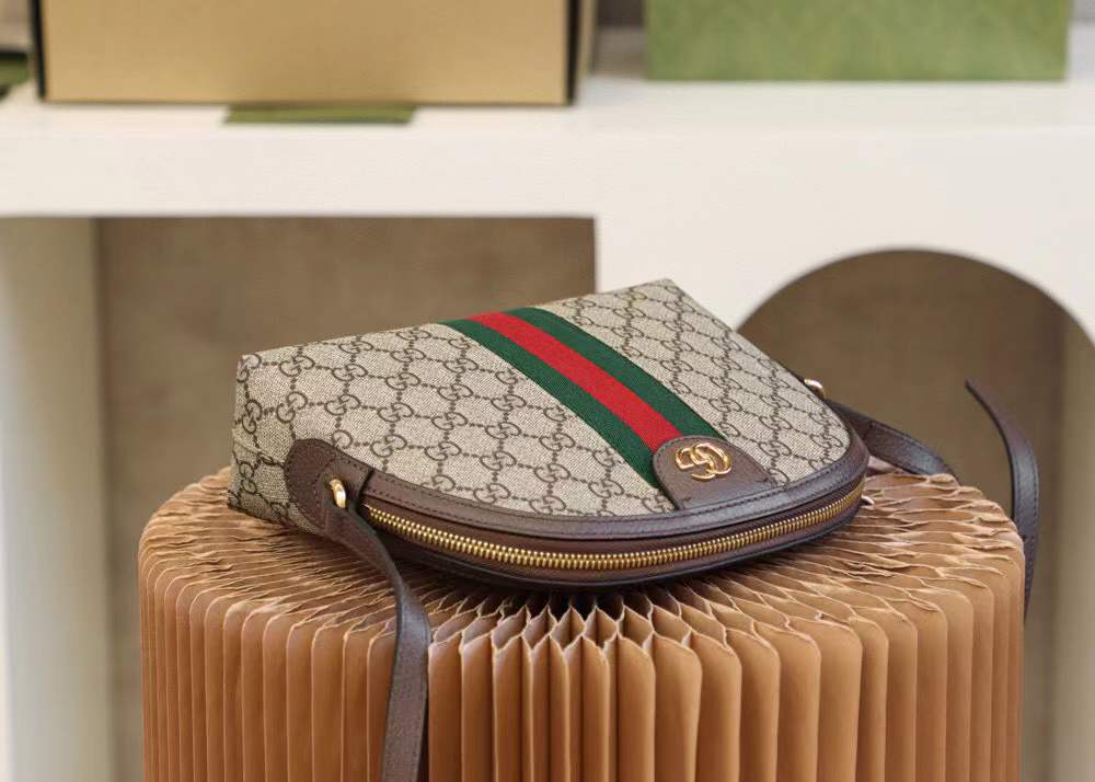 Gucci Ophidia Small GG Supreme Shoulder Bag, a dome-shaped canvas bag featuring the iconic green and red Web stripe and golden Double G hardware