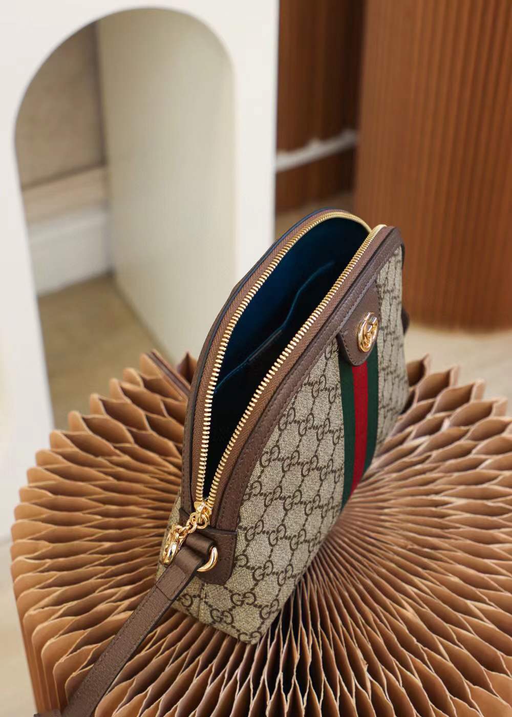 Gucci Ophidia Small GG Supreme Shoulder Bag, a dome-shaped canvas bag featuring the iconic green and red Web stripe and golden Double G hardware