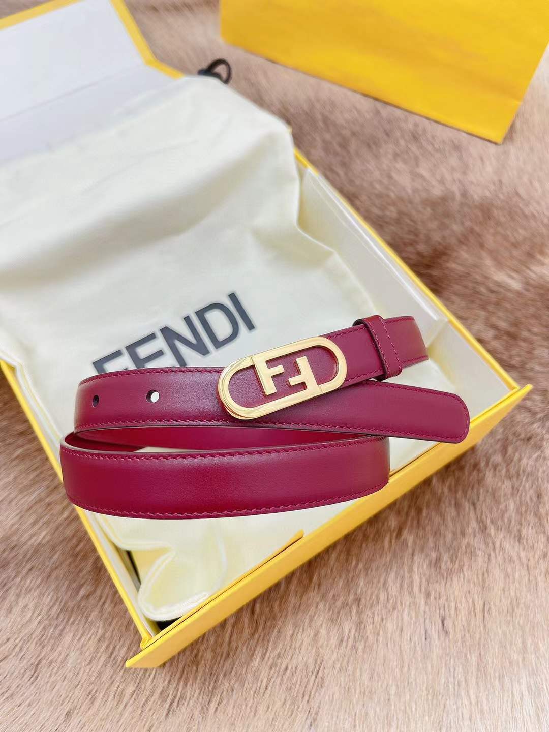 Fendi FF logo belt in red, featuring a gold-toned monogram buckle