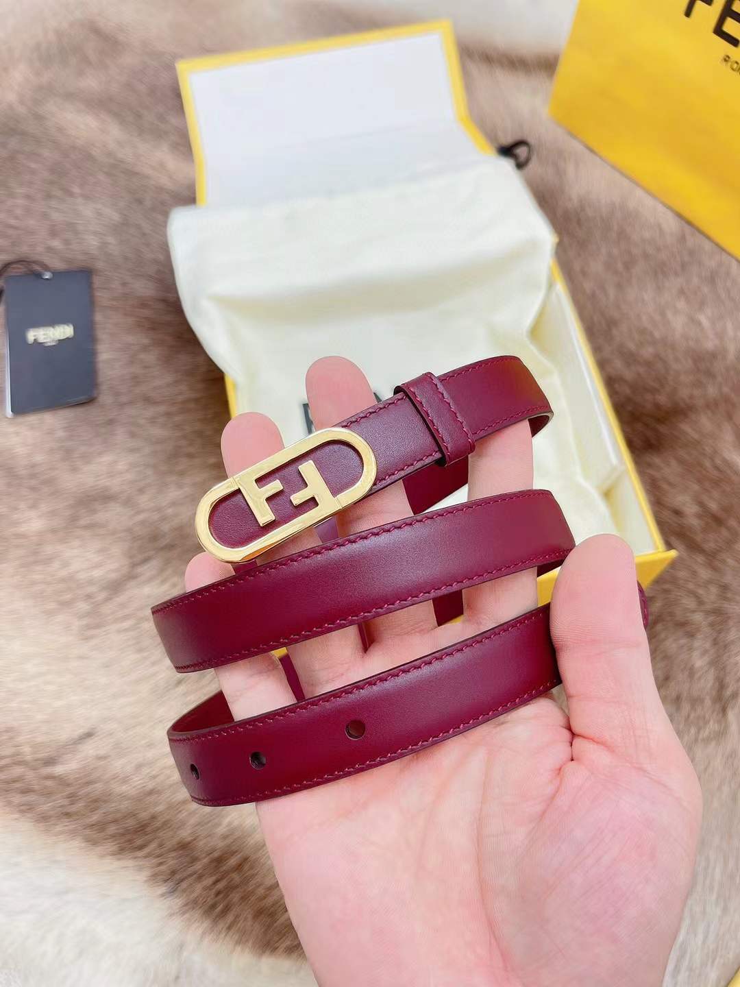 Fendi FF logo belt in red, featuring a gold-toned monogram buckle