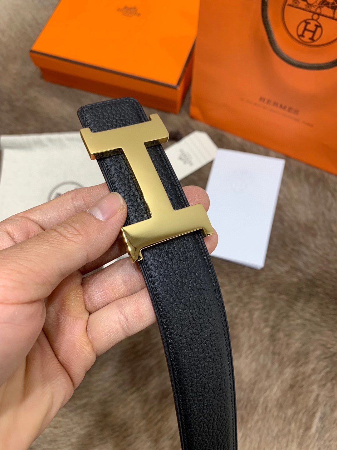 Hermès men's black leather belt featuring the brand's iconic "H" logo buckle