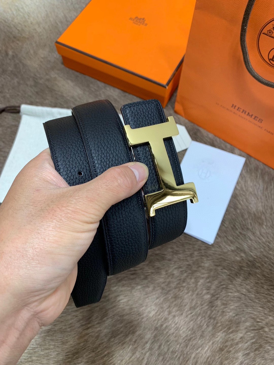 Hermès men's black leather belt featuring the brand's iconic "H" logo buckle