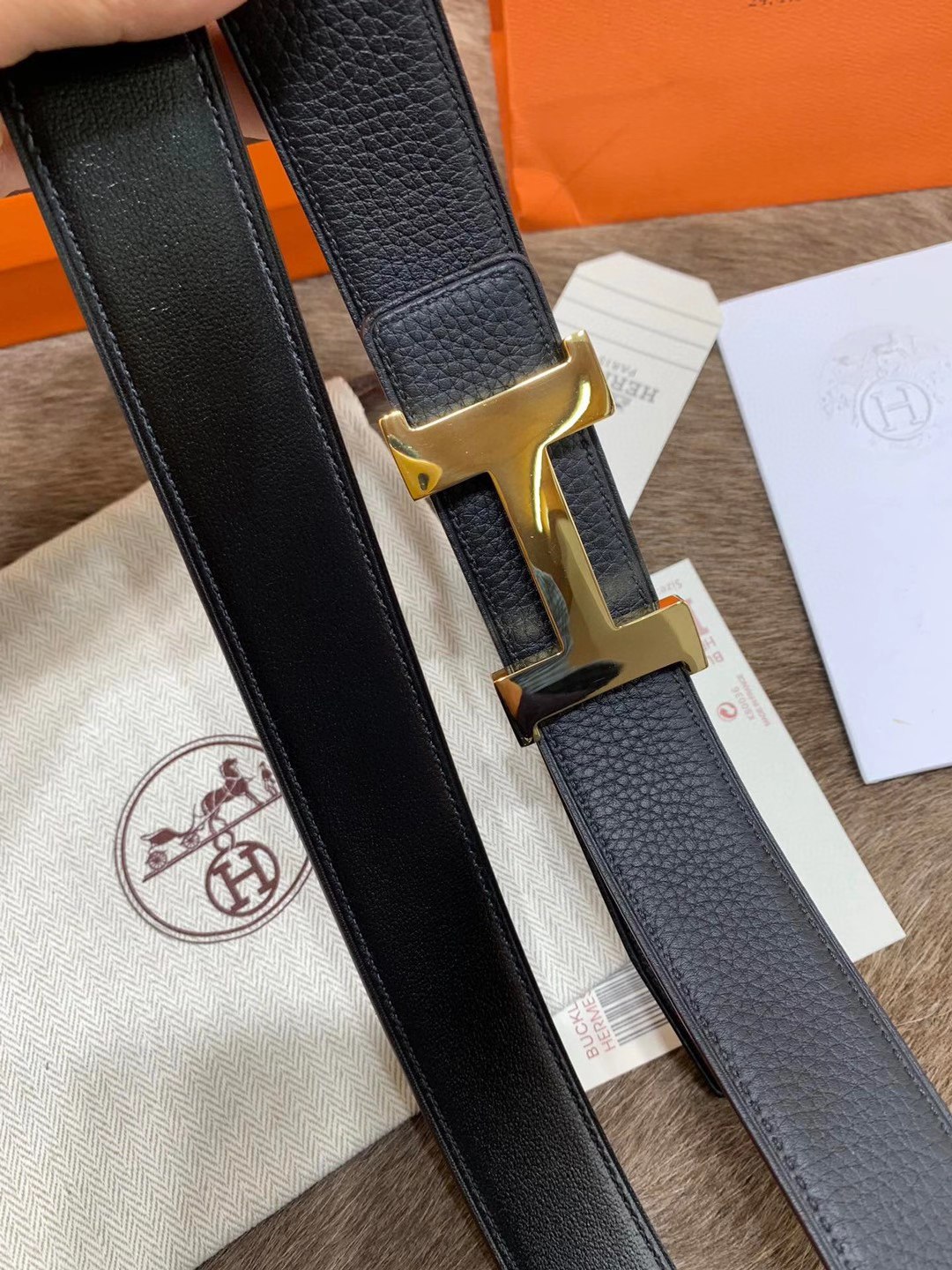 Hermès men's black leather belt featuring the brand's iconic "H" logo buckle