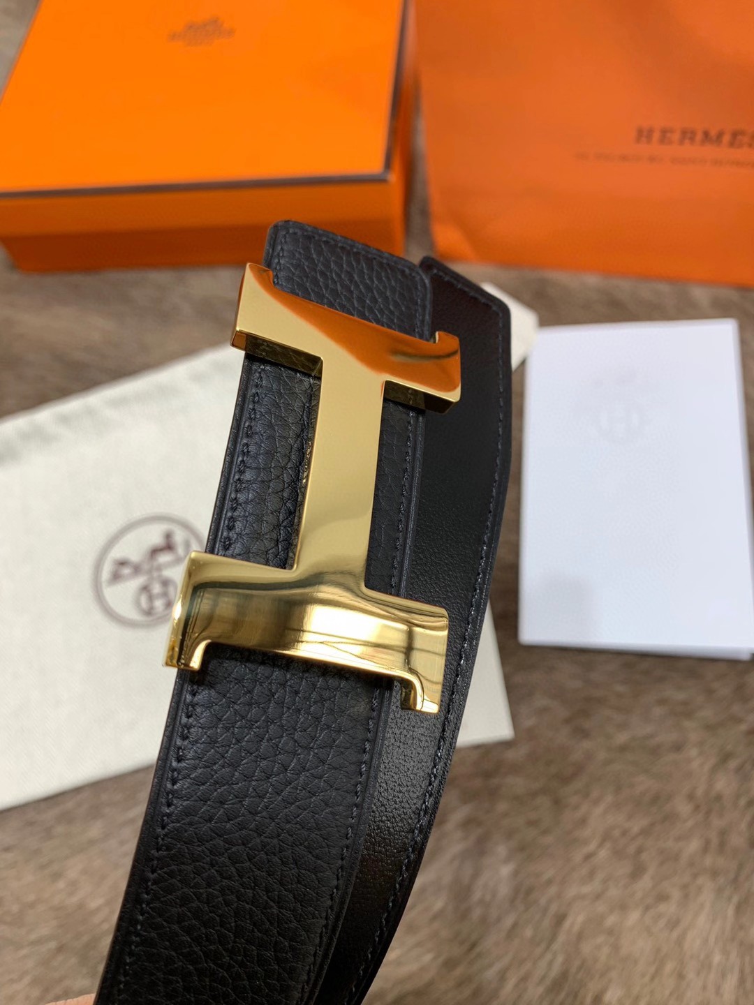 Hermès men's black leather belt featuring the brand's iconic "H" logo buckle