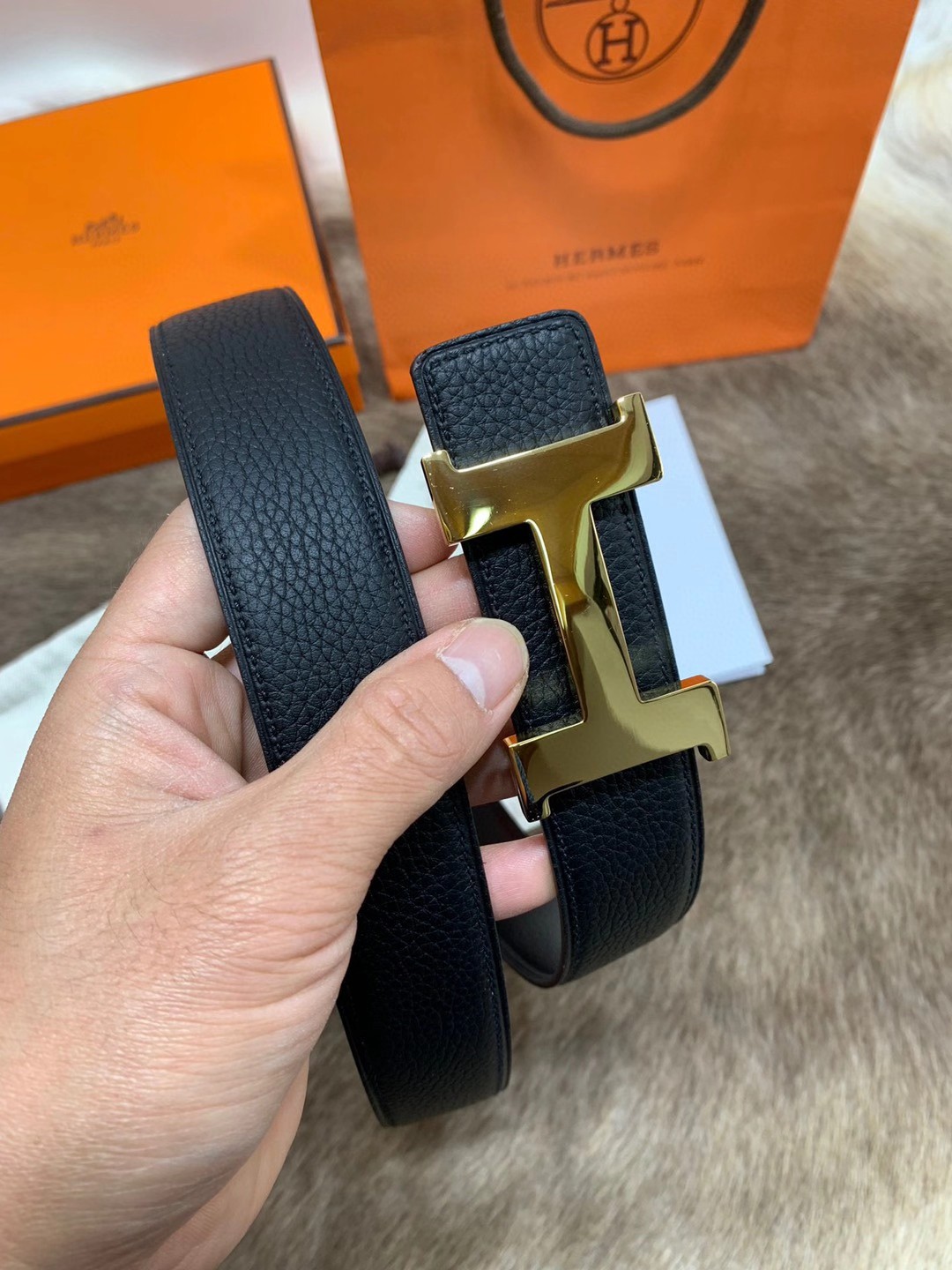 Hermès men's black leather belt featuring the brand's iconic "H" logo buckle
