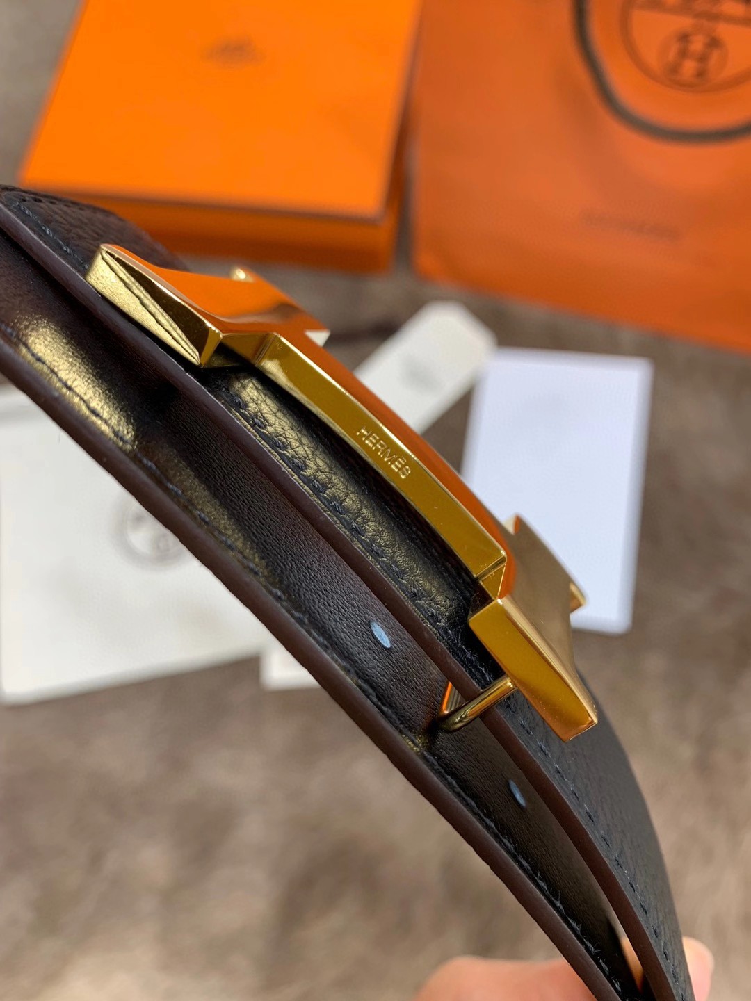 Hermès men's black leather belt featuring the brand's iconic "H" logo buckle