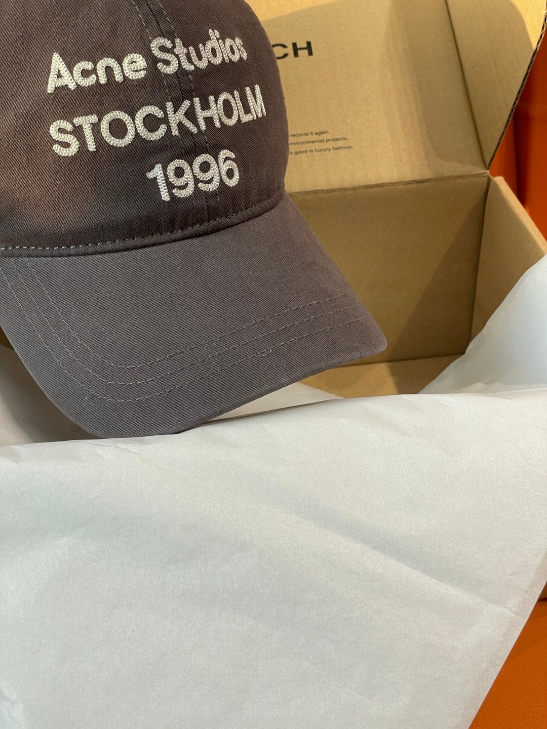 Acne Studios Stockholm 1996 cap in faded black crafted from washed cotton twill with an embroidered logo on the front panel