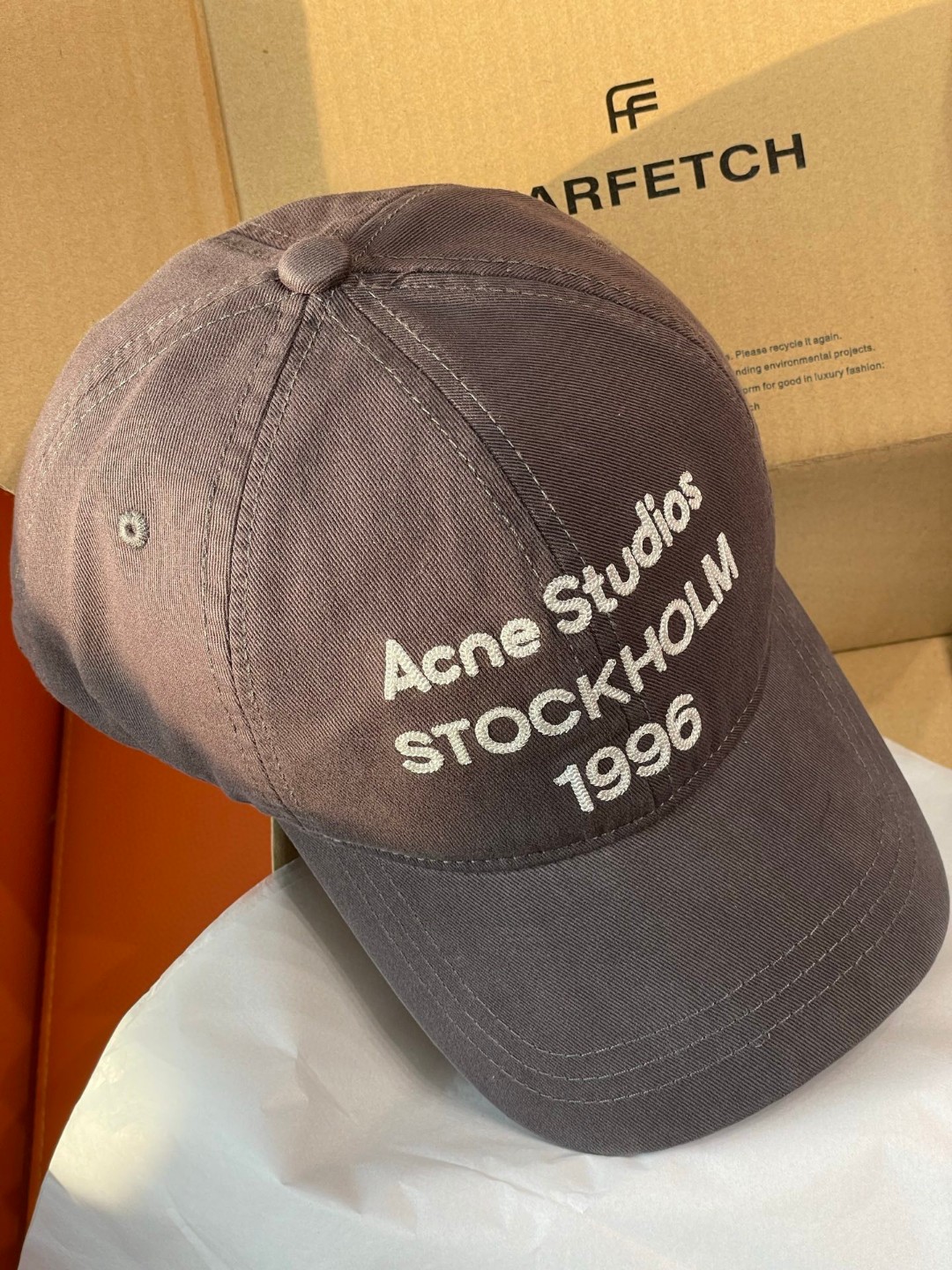 Acne Studios Stockholm 1996 cap in faded black crafted from washed cotton twill with an embroidered logo on the front panel