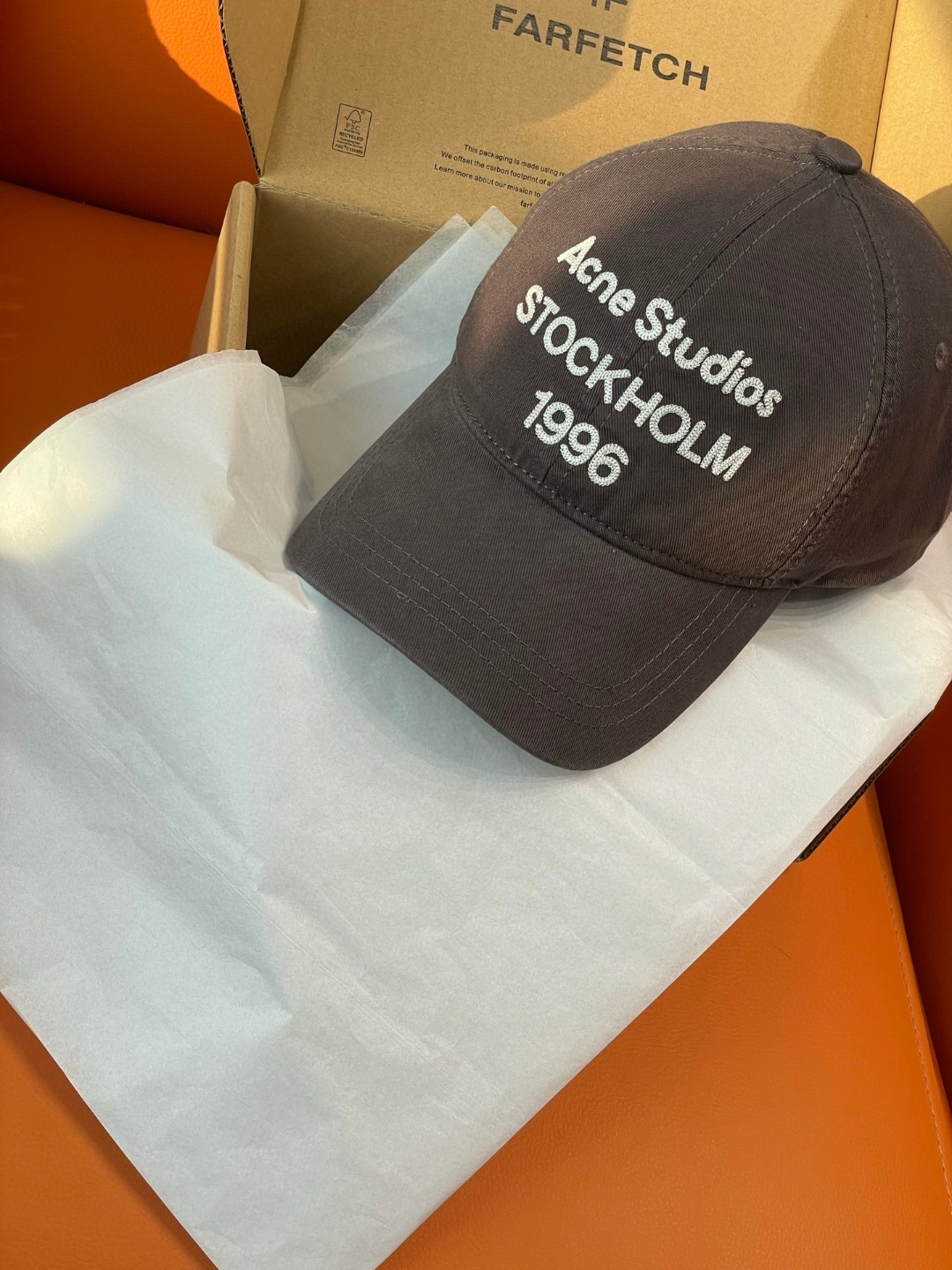 Acne Studios Stockholm 1996 cap in faded black crafted from washed cotton twill with an embroidered logo on the front panel