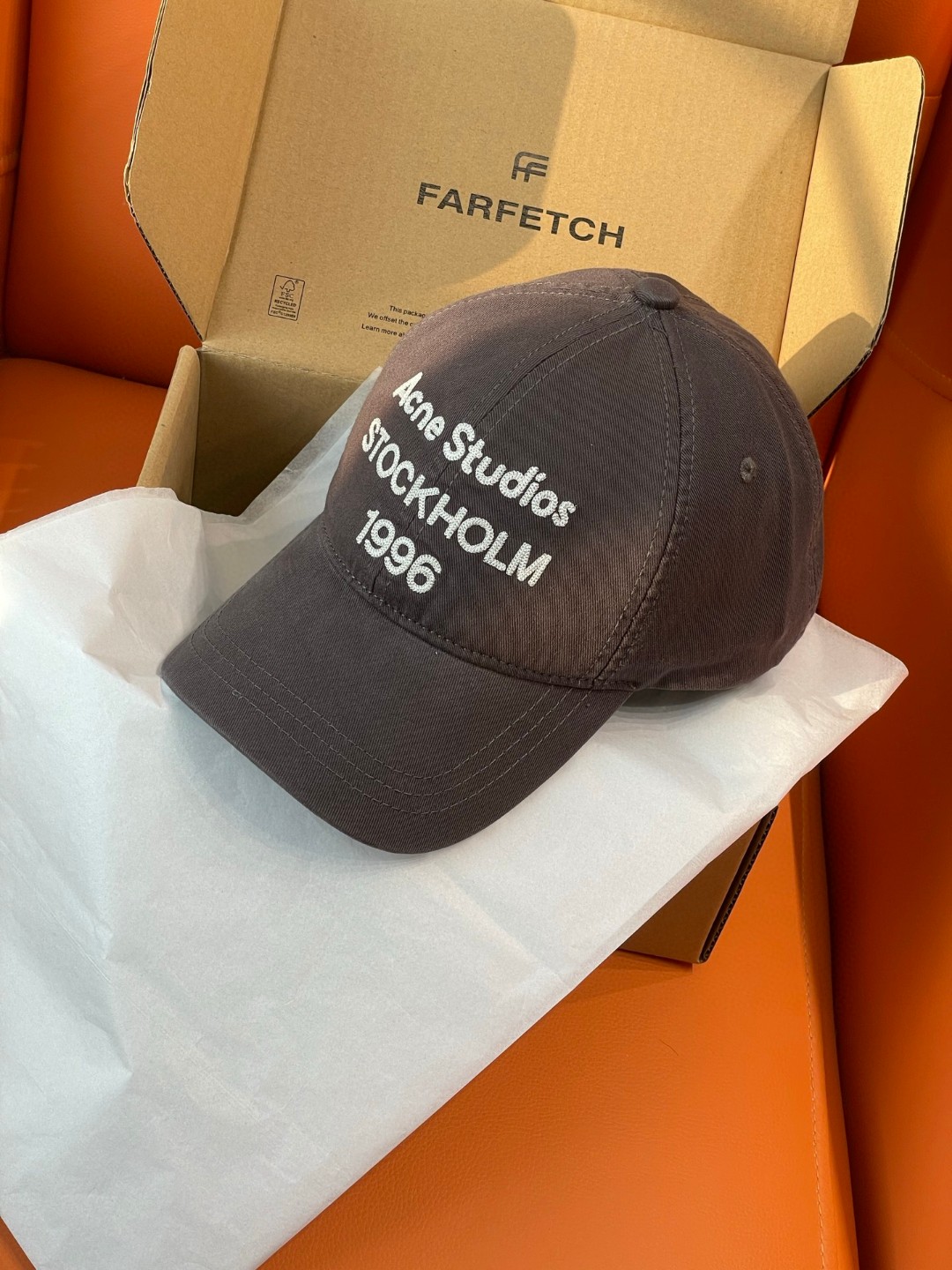 Acne Studios Stockholm 1996 cap in faded black crafted from washed cotton twill with an embroidered logo on the front panel