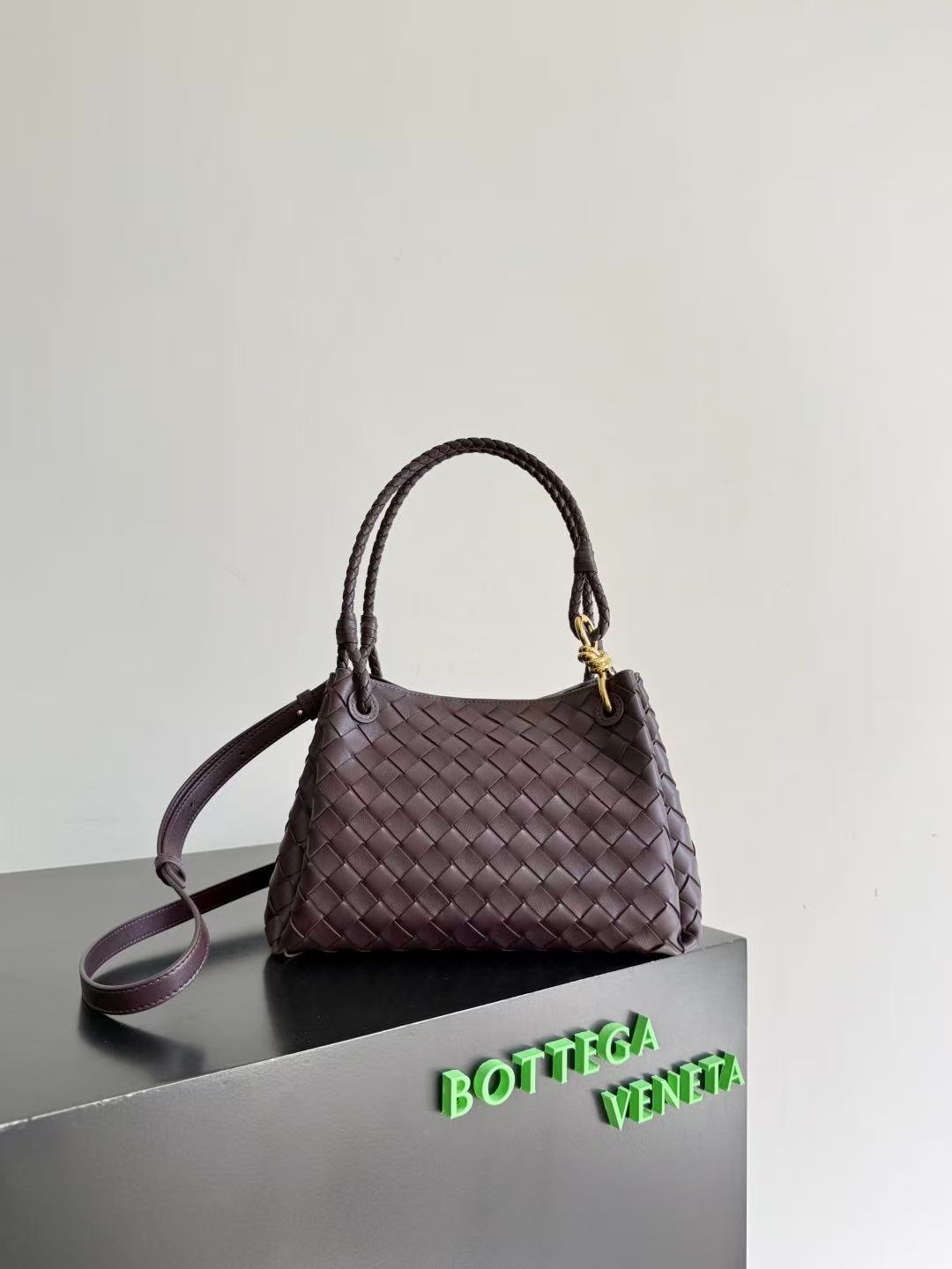 Bottega Veneta Parachute shoulder bag in a dark barolo or burgundy color, featuring the brand's signature intrecciato woven leather design