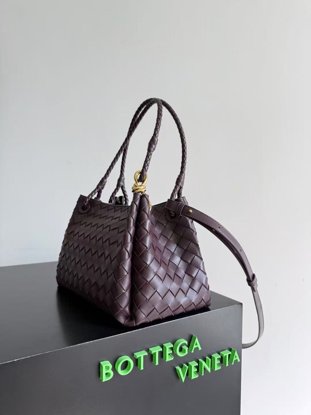 Bottega Veneta Parachute shoulder bag in a dark barolo or burgundy color, featuring the brand's signature intrecciato woven leather design