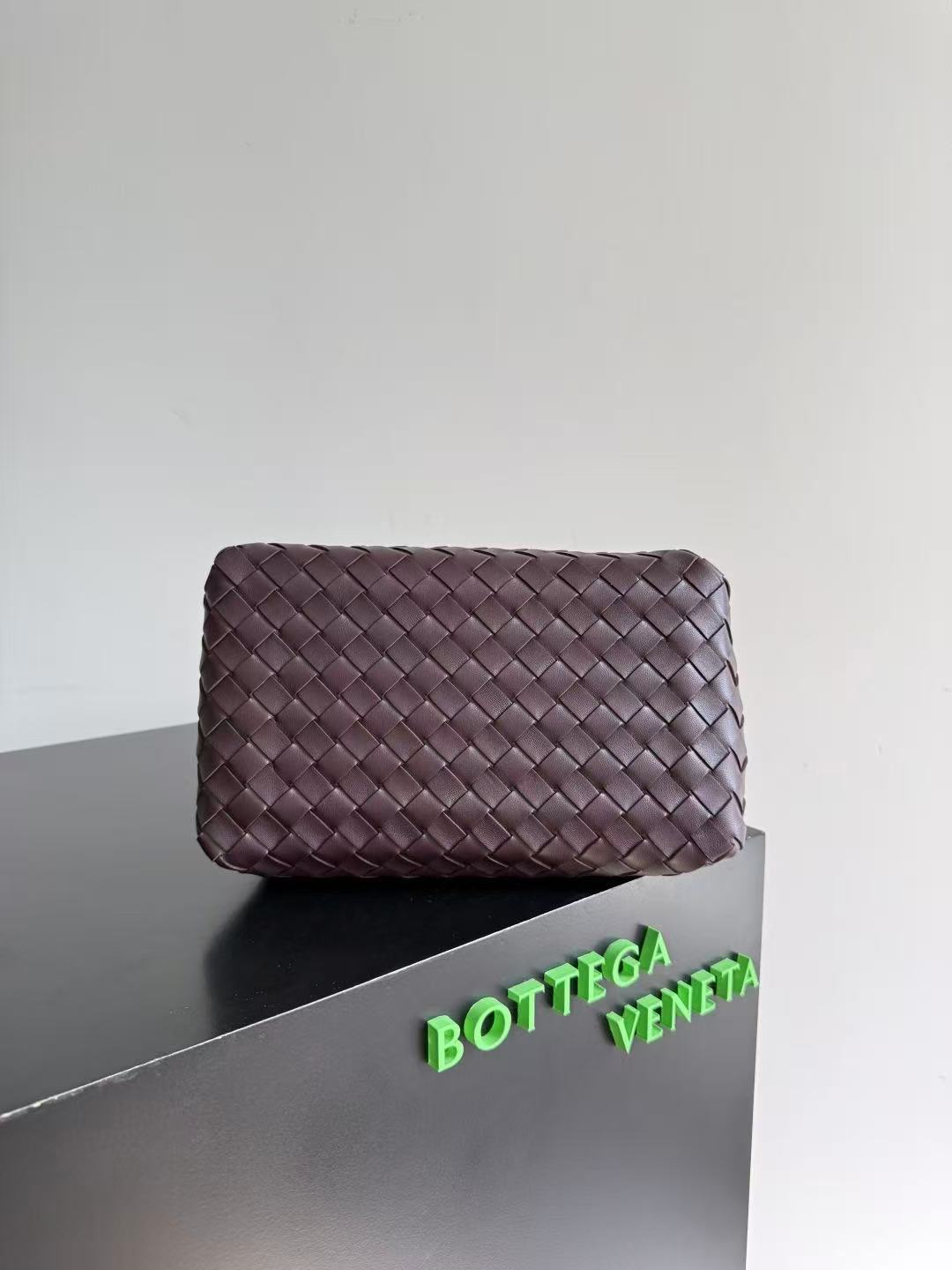 Bottega Veneta Parachute shoulder bag in a dark barolo or burgundy color, featuring the brand's signature intrecciato woven leather design