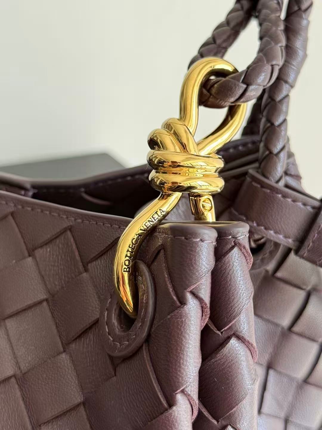 Bottega Veneta Parachute shoulder bag in a dark barolo or burgundy color, featuring the brand's signature intrecciato woven leather design