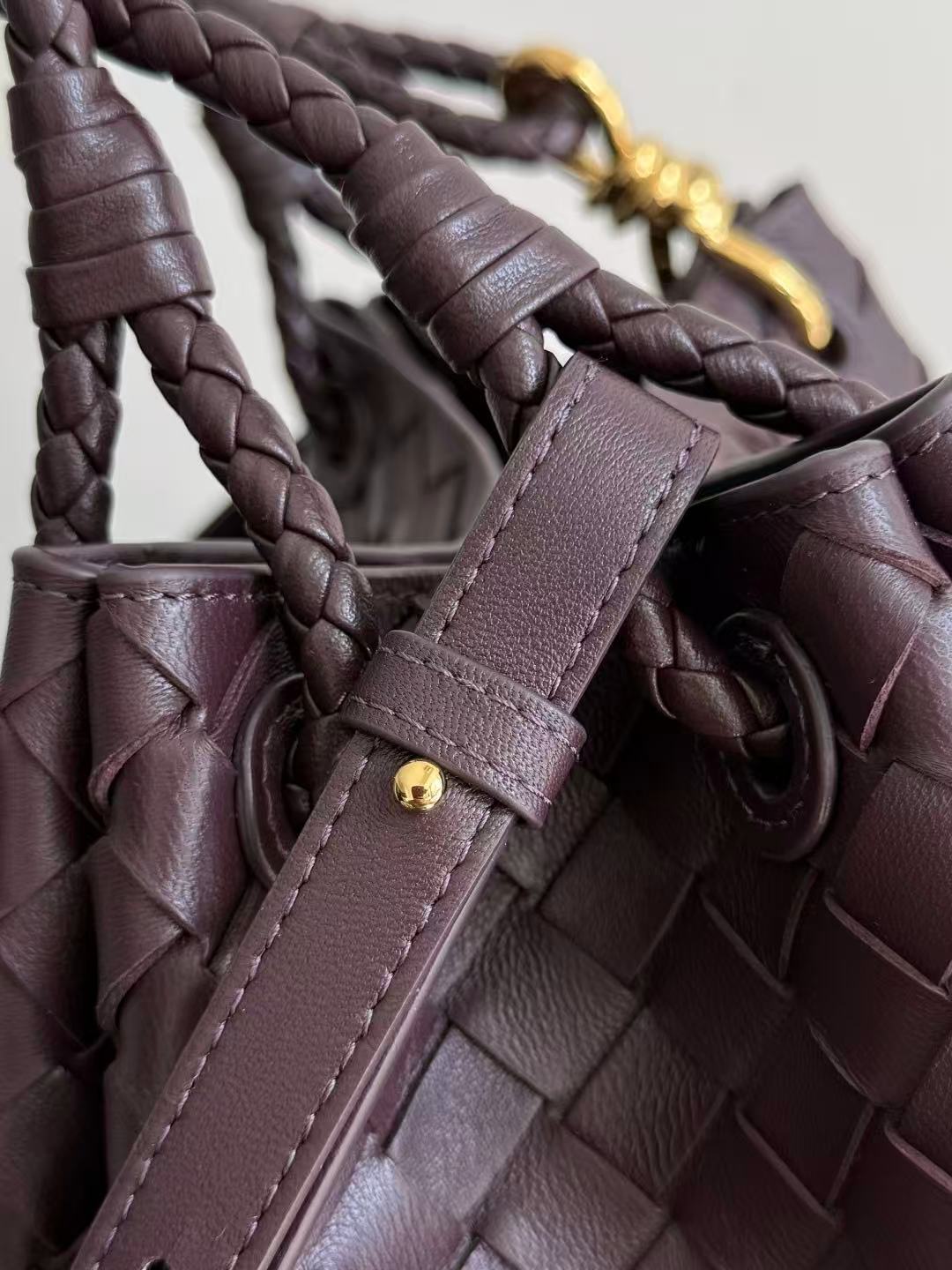 Bottega Veneta Parachute shoulder bag in a dark barolo or burgundy color, featuring the brand's signature intrecciato woven leather design