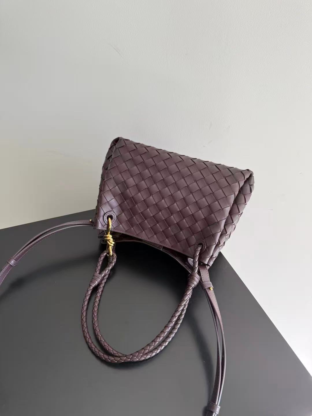 Bottega Veneta Parachute shoulder bag in a dark barolo or burgundy color, featuring the brand's signature intrecciato woven leather design