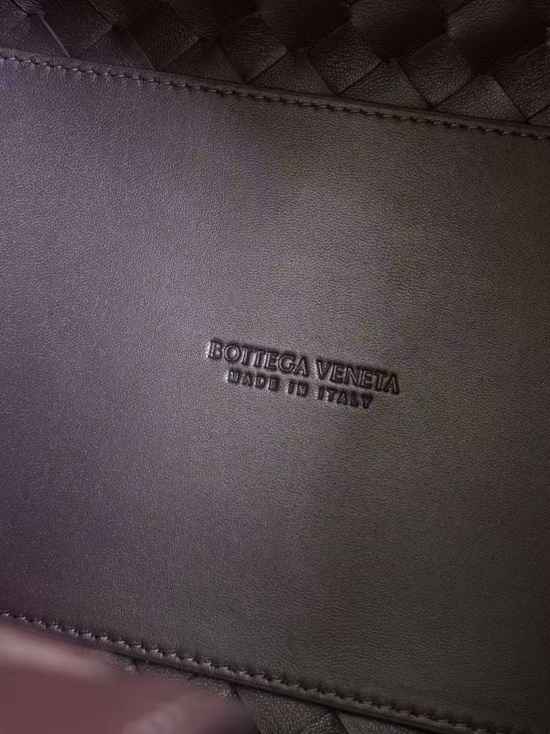 Bottega Veneta Parachute shoulder bag in a dark barolo or burgundy color, featuring the brand's signature intrecciato woven leather design