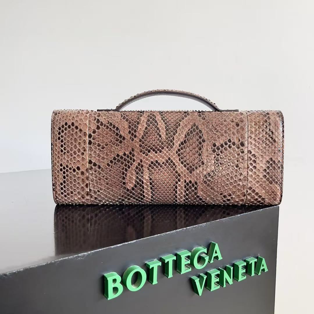 Bottega Veneta Andiamo clutch in python leather featuring a signature gold-tone knot closure