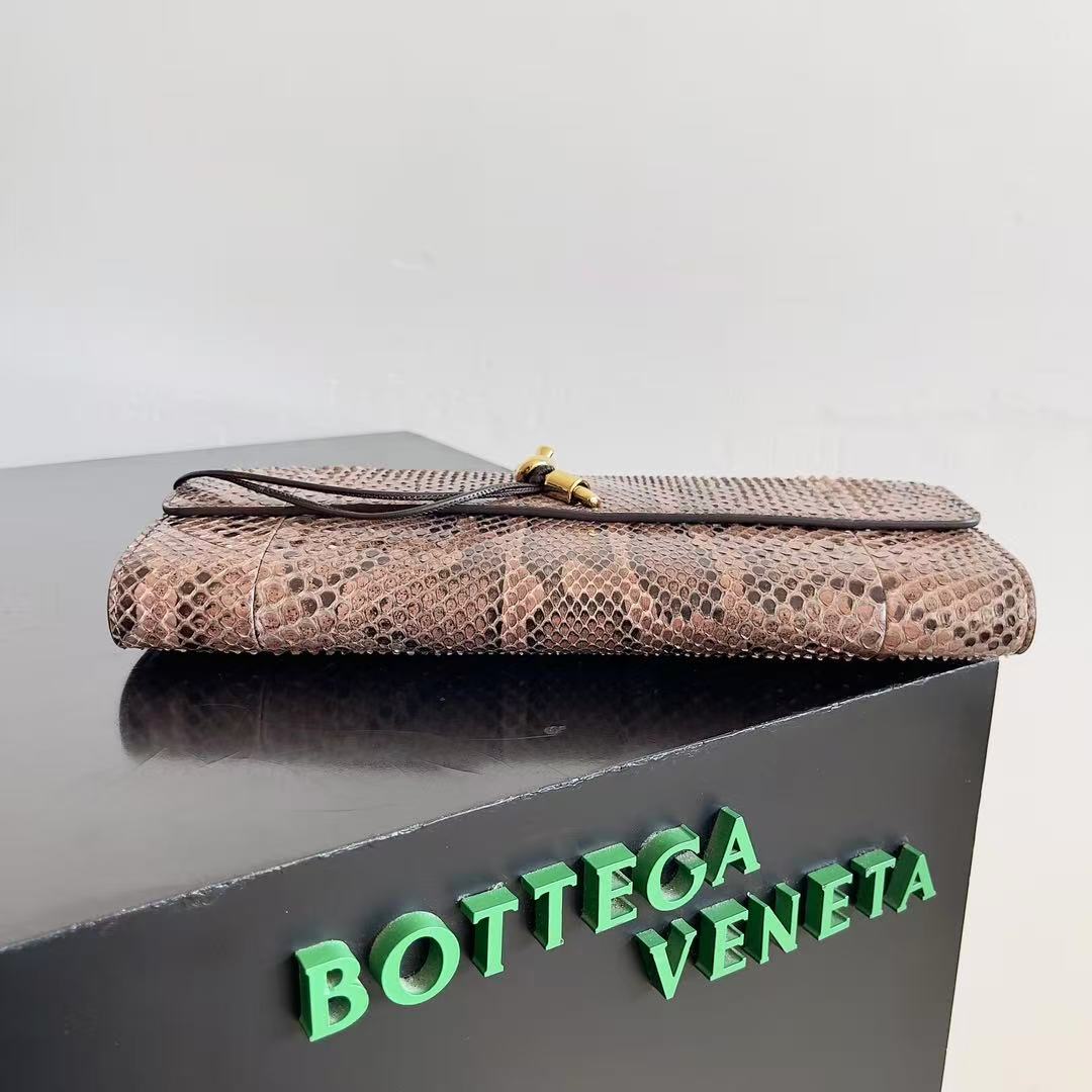 Bottega Veneta Andiamo clutch in python leather featuring a signature gold-tone knot closure