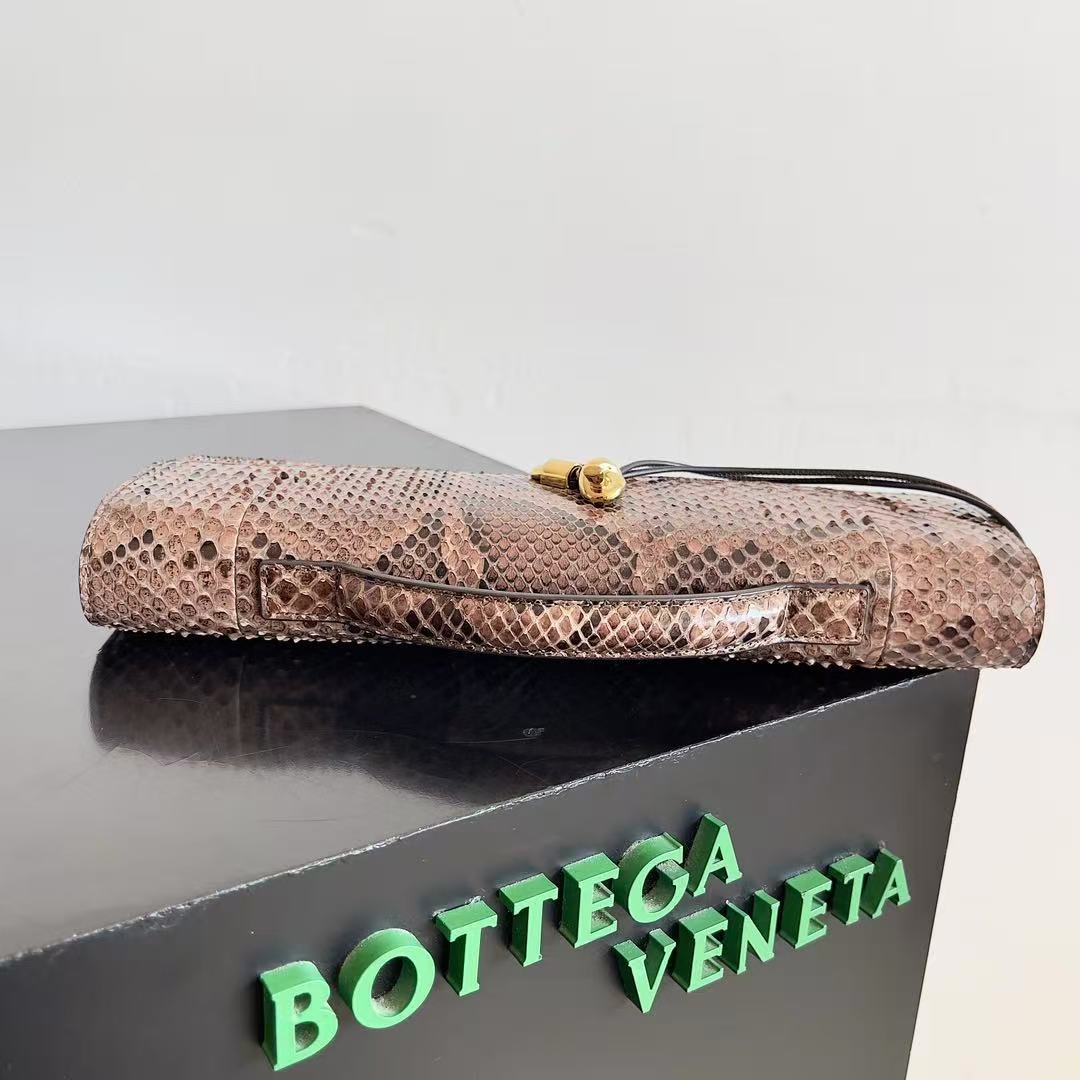 Bottega Veneta Andiamo clutch in python leather featuring a signature gold-tone knot closure