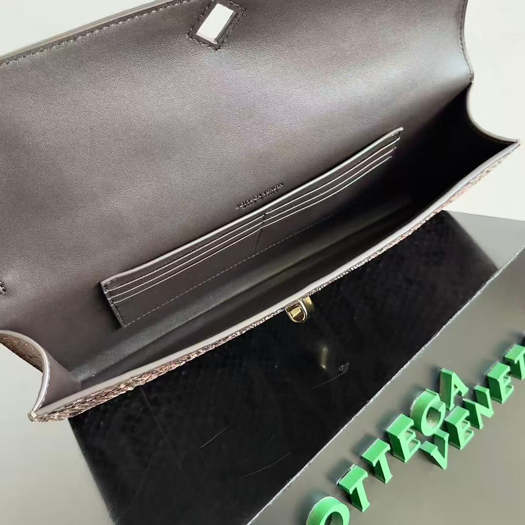Bottega Veneta Andiamo clutch in python leather featuring a signature gold-tone knot closure