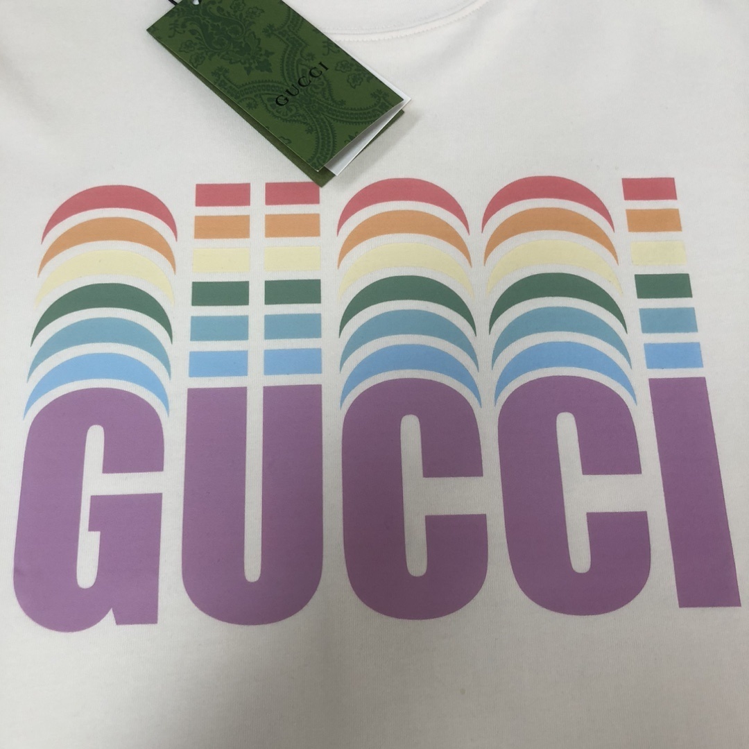 Gucci white T-shirt features a colorful, retro-inspired rainbow logo graphic