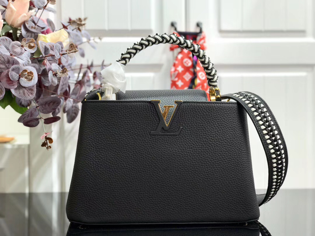 LV Capucines handbag, likely in the BB size, is crafted from black Taurillon leather and features a distinctive jewelry-inspired chain top handle and signature LV initials