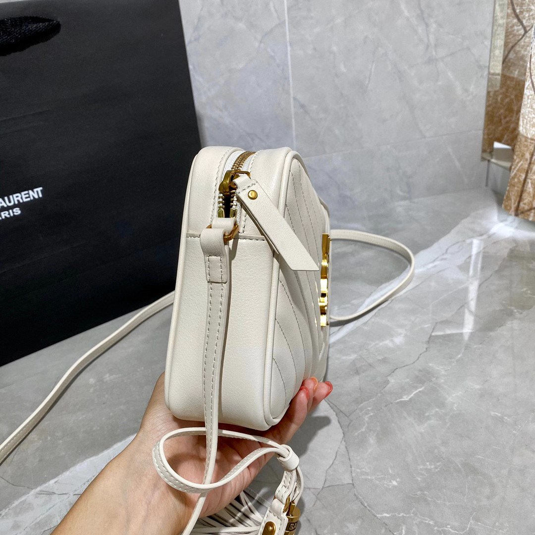 Saint Laurent Lou camera bag is crafted from white quilted leather and features the signature gold-tone YSL monogram plaque.