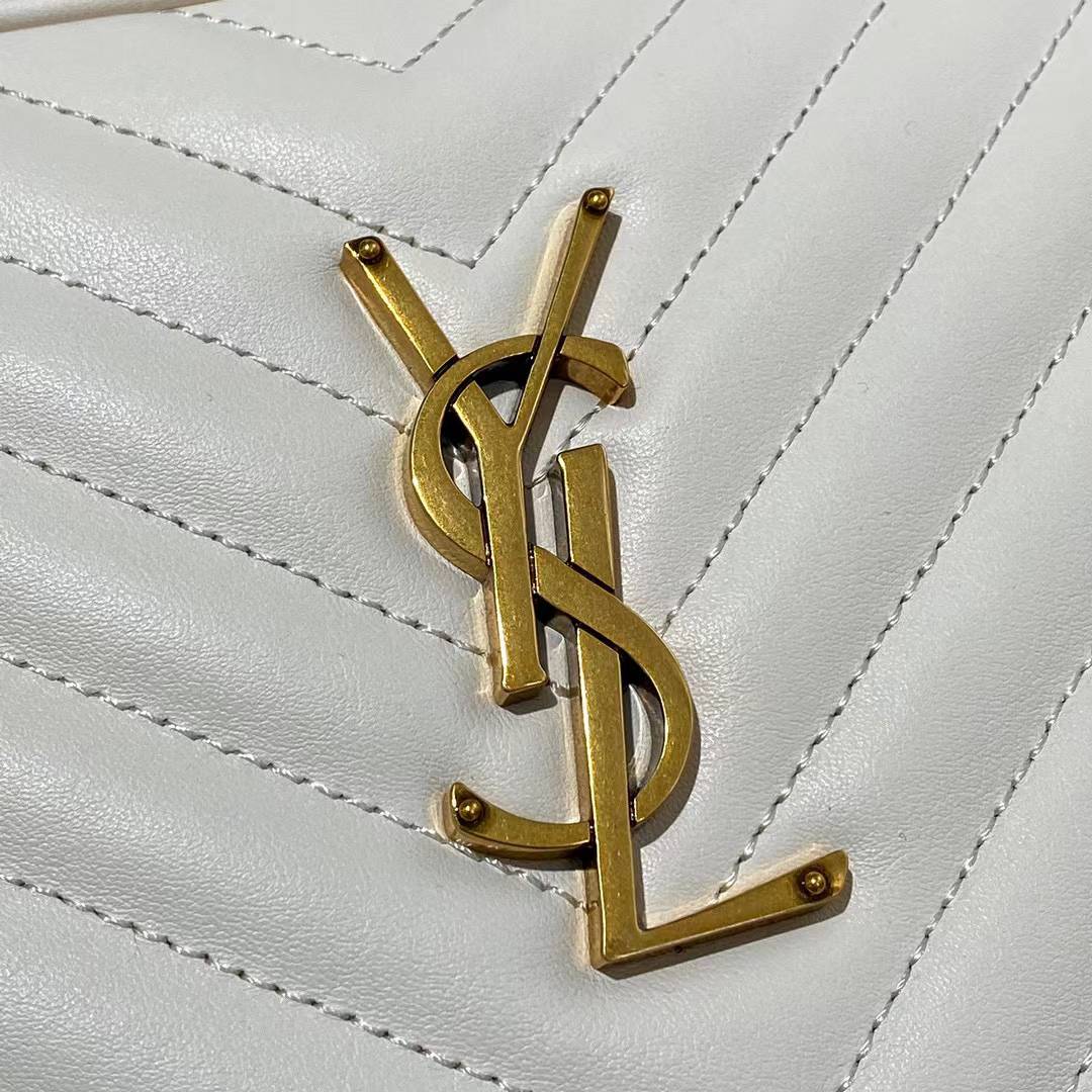 Saint Laurent Lou camera bag is crafted from white quilted leather and features the signature gold-tone YSL monogram plaque.