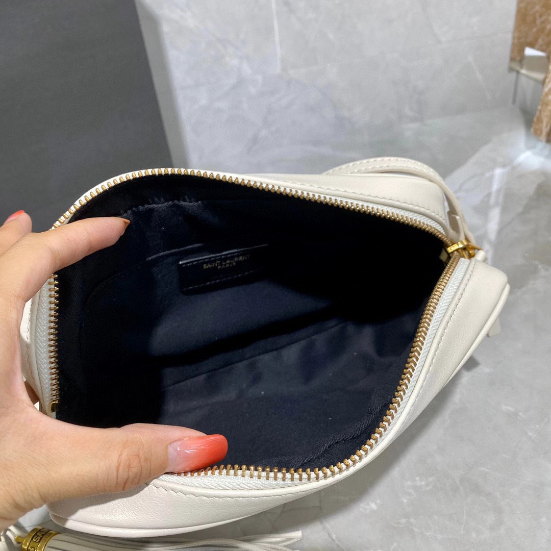 Saint Laurent Lou camera bag is crafted from white quilted leather and features the signature gold-tone YSL monogram plaque.